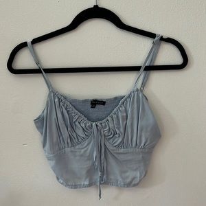 A cropped blue tank from Pacsun. Slightly worn. Very flattering.